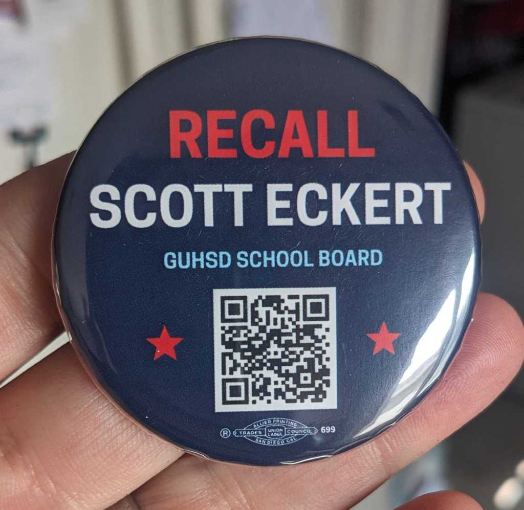 Photo of a button that says "Recall Scott Eckert. GUHSD School Board." with a QR code
